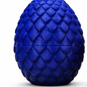 May include: A white ceramic mug with a black handle and the text "But First, Coffee" in a bold, black font. The mug is sitting on a wooden surface.