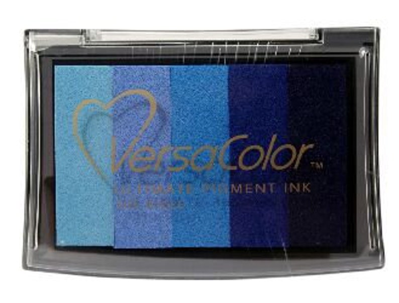 May include: A VersaColor ink pad with a heart logo. The pad has five colors of ink: light blue, medium blue, dark blue, navy blue, and black.