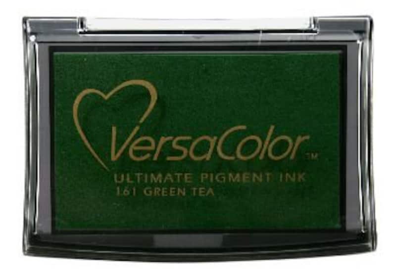 May include: A green ink pad with the text "VersaColor" and "Ultimate Pigment Ink 181 Green Tea" on the front.