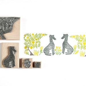 May include: A set of five wood mounted rubber stamps featuring a tree, two dogs, and two lemon trees with yellow flowers. The stamps are designed for crafting and scrapbooking.