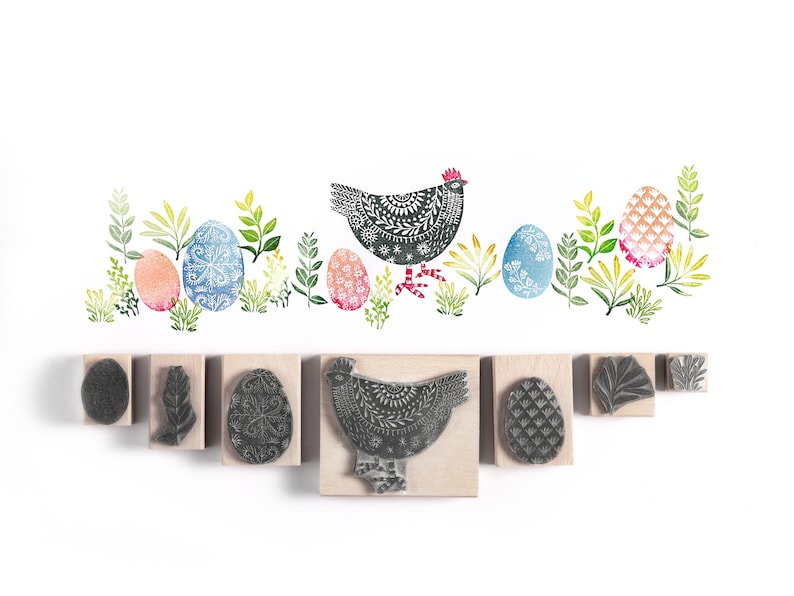 May include: A set of nine rubber stamps featuring a black and white hen, leaves, and patterned eggs. The stamps are on a white background.