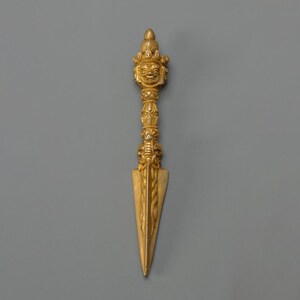 May include: A white ceramic mug with a black handle and the text "But First, Coffee" in a handwritten style. The mug is on a white surface. The mug is 10 cm tall.