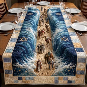 May include: A quilted table runner featuring a biblical scene with figures and camels walking between blue and white waves. The runner has a sand-colored path and Star of David symbols. The edges are bordered with blue and tan squares.