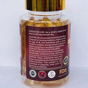 May include: A clear bottle with a gold cap filled with yellow capsules. The label includes text about suggested use, warnings, and FDA approval. The bottle is for a dietary supplement.