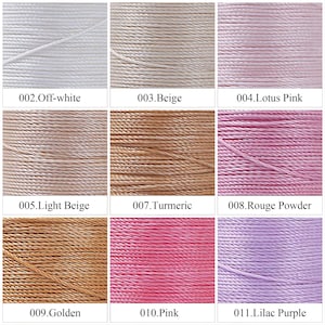 May include: Nine color swatches of thread, each with a different color and number. Colors include off-white, beige, lotus pink, light beige, turmeric, rouge powder, golden, pink, and lilac purple. Each swatch has a corresponding number.