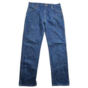 May include: Blue denim jeans with a classic five-pocket design. The jeans have a straight leg cut and a button and zip closure. The denim has a faded, worn look. The jeans are a medium wash blue.