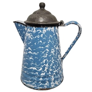 May include: Vintage blue and white enamelware coffee pot with a dark gray lid and handle. The pot features a classic speckled pattern and a spout for pouring. A charming addition to any kitchen.