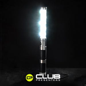 May include: A bright white LED light stick with a silver metal top and bottom. The middle section is black with a woven texture. The light is turned on, emitting a bright white glow. The logo for "CLUB PRESENTERS" is at the bottom.