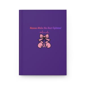 May include: A purple journal with the text "Nurses Make the Best Fighters!" in pink and orange. The cover features a pink bow, pink boxing gloves, and a pink ribbon, symbolizing support for breast cancer awareness.
