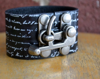 Distressed black leather cuff with old scripts hand stamped - All new materials Handmade