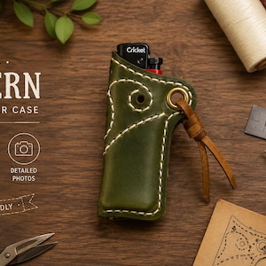 May include: A dark olive green leather lighter case with white contrast stitching, a brass eyelet, and a brown leather cord. The case holds a black Cricket lighter. Text on the image reads: DIGITAL PATTERN LEATHER LIGHTER CASE.