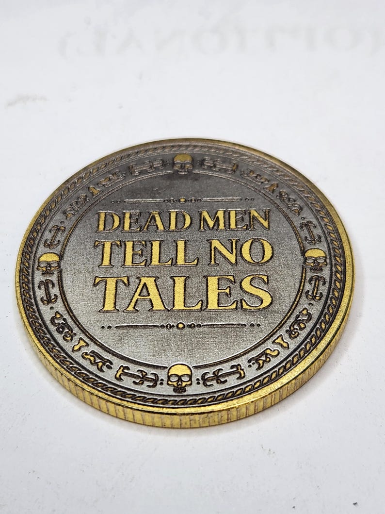 Ornate coin with dense gothic lettering and raised border, used in a laser test matrix for fine detail checks.