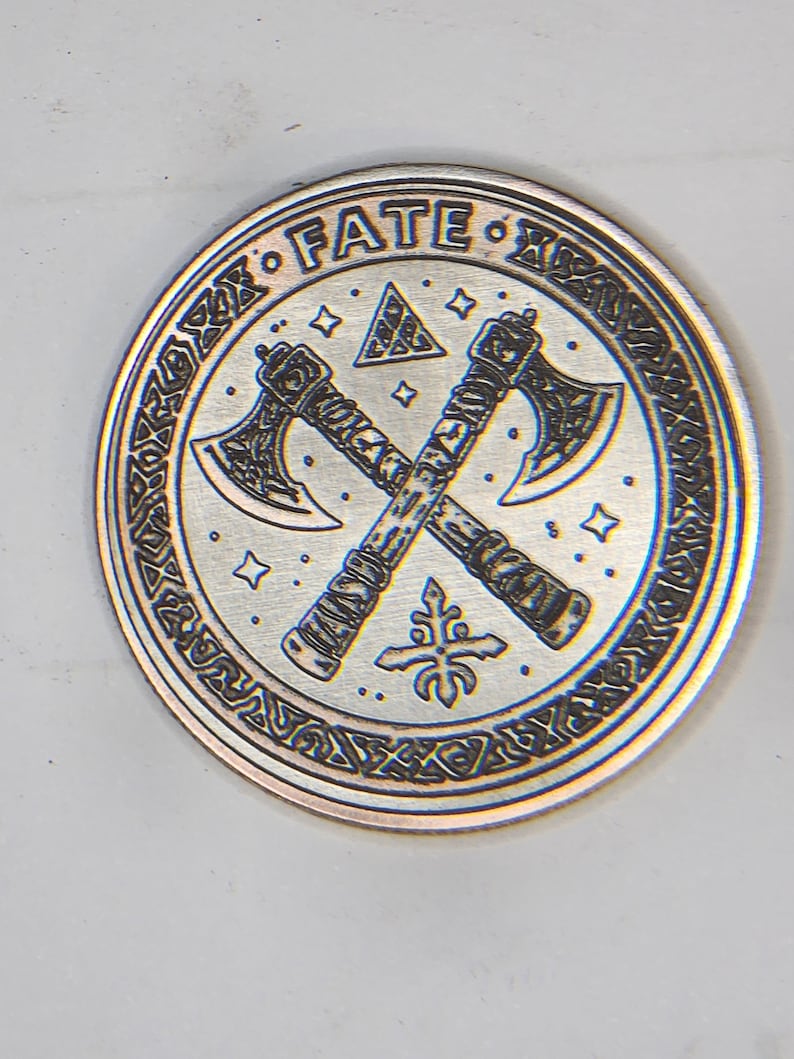 Round test coin with central geometric motif and textured fill, demonstrating laser parameters guide results.