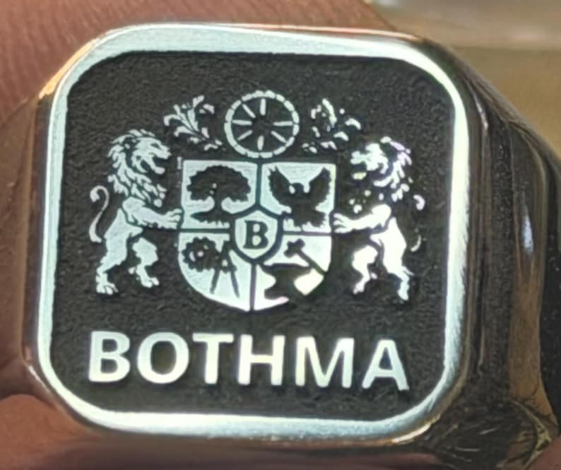 Polished signet plate engraved with detailed coat of arms and BOTHMA text, square metal engraving sample.