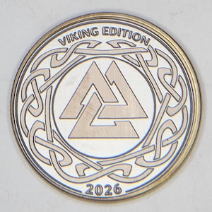 Silver-toned coin with interlaced Viking knot and 2026 date, high contrast metal engraving settings sample.