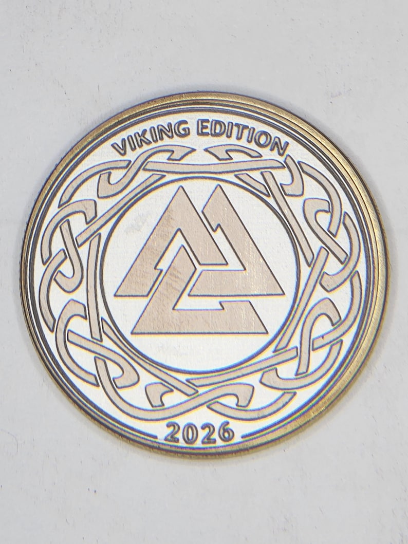 Silver-toned coin with interlaced Viking knot and 2026 date, high contrast metal engraving settings sample.