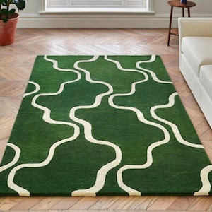 May include: A set of three ceramic mugs with a speckled, matte finish in cream, light grey, and dark grey. Each mug has a simple, minimalist design, suitable for coffee or tea.