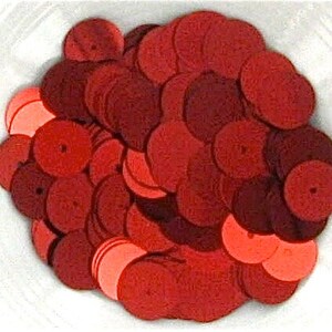 May include: A pile of red sequins, perfect for crafting and decorating.