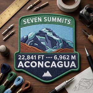 May include: An embroidered patch featuring a mountain landscape with the text SEVEN SUMMITS at the top and ACONCAGUA at the bottom. The patch displays the elevation as 22,841 FT and 6,962 M in white thread against a dark blue background.