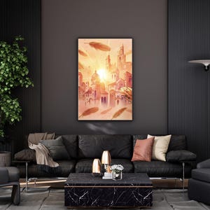 May include: A framed watercolor painting of a cityscape with warm orange and pink hues, featuring buildings and a bright sun. The artwork is displayed above a black leather sofa with decorative pillows, a coffee table, and a potted plant.