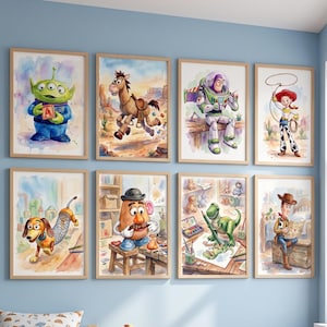 May include: A collection of eight framed watercolor prints featuring characters from the Toy Story movie franchise. The prints are displayed on a light blue wall in a child's bedroom. The room also includes a bed, a nightstand, and toys.