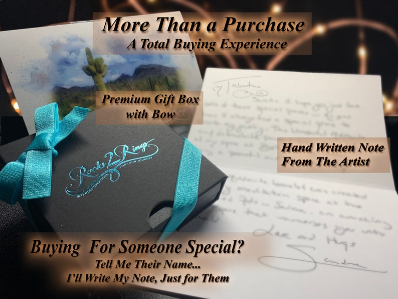 May include: A black gift box with a blue ribbon and bow. The box has the words "Rocks 2 Ring" printed on it. The box is sitting on a white card with the text "Buying For Someone Special? Tell Me Their Name... I'll Write My Note, Just for Them".