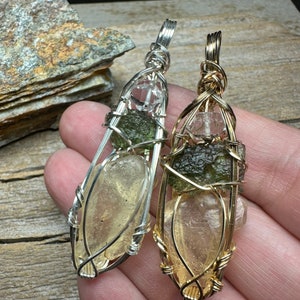 May include: Two wire-wrapped pendants with clear quartz, green aventurine, and golden healer crystals. The pendant on the left is wrapped in silver wire, and the pendant on the right is wrapped in gold wire.