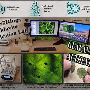 May include: A close-up of a green moldavite stone being examined under a microscope. The image shows the stone's unique texture and bubbles, which are characteristic of moldavite. The text "Rocks2Rings Moldavite Certification Lab" is visible in the image, indicating that the stone has been professionally certified.