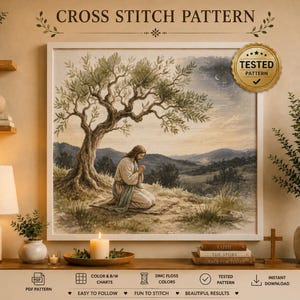 May include: A framed cross stitch pattern featuring a landscape illustration of a figure kneeling in prayer under an olive tree. The image includes the text CROSS STITCH PATTERN and a gold seal with the text TESTED PATTERN with a checkmark.