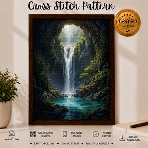 May include: A cross stitch pattern featuring a waterfall cascading into a pool within a rocky, tree-lined cave. The framed artwork displays lush green foliage and blue water. Text includes Cross Stitch Pattern and Tested Pattern.