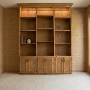 May include: A set of three ceramic mugs with a speckled, matte finish. The mugs are in shades of cream, light gray, and dark gray. Each mug has a simple, minimalist design and a rounded handle.