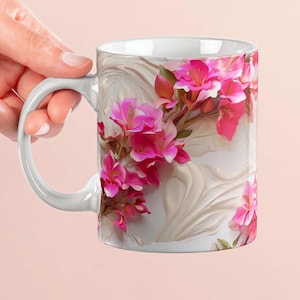 May include: White ceramic mug featuring a floral design with pink flowers and green leaves. The flowers are set against a cream-colored background with a textured, swirling pattern. The mug has a white handle.