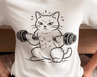 Könnte beinhalten: Weißes T-Shirt mit einer schwarz-weißen Illustration einer Katze, die Hanteln hebt. Die Katze hat einen grimmigen Gesichtsausdruck. Das Design ist einfach und auffällig, passend für Katzenliebhaber und Fitnessinteressierte. Die Hanteln sind etwa 10 cm lang.