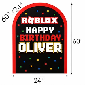 May include: An arched sign measuring 60 inches by 24 inches with a black background and a red border. It features the text ROBLOX, HAPPY BIRTHDAY, and OLIVER in white and red pixelated fonts, accented by small scattered red, blue, and yellow squares.