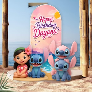 May include: A decorative birthday backdrop featuring a pink and orange sunset sky with the text "Happy Birthday Dayana". The display includes a cartoon girl with a pink flower in her hair and three blue and pink alien characters on a sandy base.
