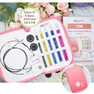 May include: A pink zippered case containing a Knit Pro ZING starter interchangeable needle set. The set includes colorful knitting needles in various sizes, ranging from US 2.5 to 8, and accessories. The case is open, displaying the needles and other components.