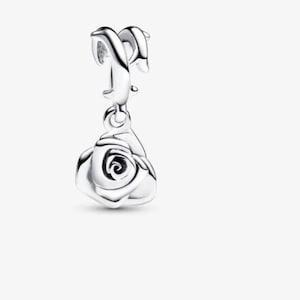 May include: A polished silver charm featuring a dangling rose pendant. The charm has a curved, smooth bail at the top designed for attachment to a bracelet or necklace chain, with a detailed, layered rose flower shape hanging below it.