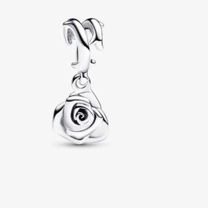 May include: A polished silver charm featuring a dangling rose pendant. The charm has a curved, smooth bail at the top designed for attachment to a bracelet or necklace chain, with a detailed, layered rose flower shape hanging below it.
