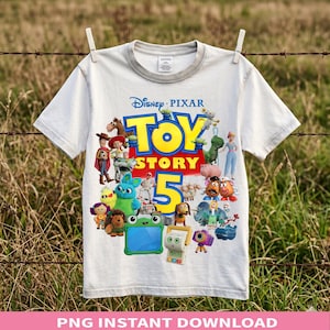 May include: A white short-sleeved t-shirt featuring a colourful graphic print of various Toy Story characters surrounding the large yellow and blue text Toy Story 5. The design includes Woody, Buzz Lightyear, Jessie, and other animated figures.