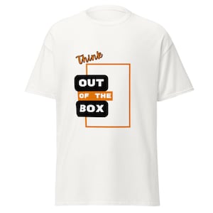 May include: A white short-sleeved t-shirt featuring a graphic design with the text "Think OUT OF THE BOX". The design includes a large orange rectangular outline, black rounded rectangles containing the words "OUT" and "BOX", and orange text.