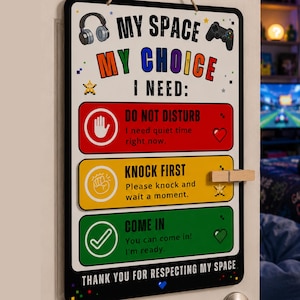 May include: A rectangular sign with the text "MY SPACE MY CHOICE I NEED:" and three colored sections. The top section is red and says "DO NOT DISTURB". The middle section is yellow and says "KNOCK FIRST". The bottom section is green and says "COME IN".