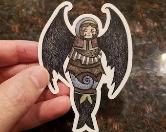 May include: A sticker of a person with black wings, a blue and green patterned body, and a spiral design on their lower body. The person has a blue hood and a worried expression.