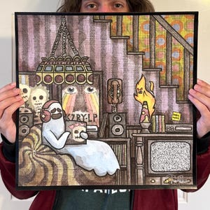 May include: A square art print featuring a ghost wearing headphones and holding a skull-themed record. The scene includes a lava lamp, a television with static, a rotary phone, and a staircase. The text K7RY-LP and we're HERE are visible.