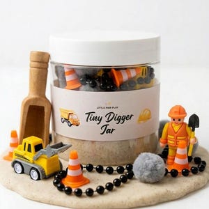 May include: A white ceramic mug with a black handle and the text "But First, Coffee" in a bold, black font. The mug is likely 11-15 ounces, perfect for a morning beverage. The design is simple and modern.