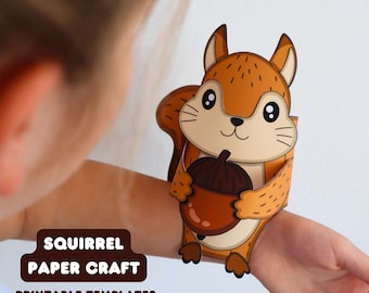 May include: A paper craft squirrel with brown fur and a dark brown acorn, featuring large black eyes and a cream-colored belly. The text SQUIRREL PAPER CRAFT PRINTABLE TEMPLATES PDF is displayed in a dark brown rounded rectangular box.