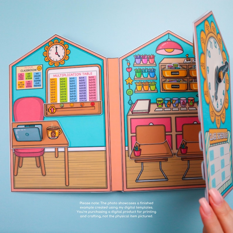 May include: A colorful papercraft classroom scene with a multiplication table, clock, and desk. The scene includes a laptop, a mug, and a pink chair. The text on the image says "Classroom" and "Multiplication Table".
