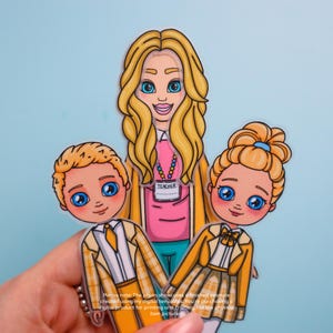 May include: A colorful illustration of a teacher and two students. The teacher has blonde hair and wears a pink shirt with a name tag that says "TEACHER". The students wear yellow plaid jackets. The image includes the text: "Please note: The photo showcases a finished example..."
