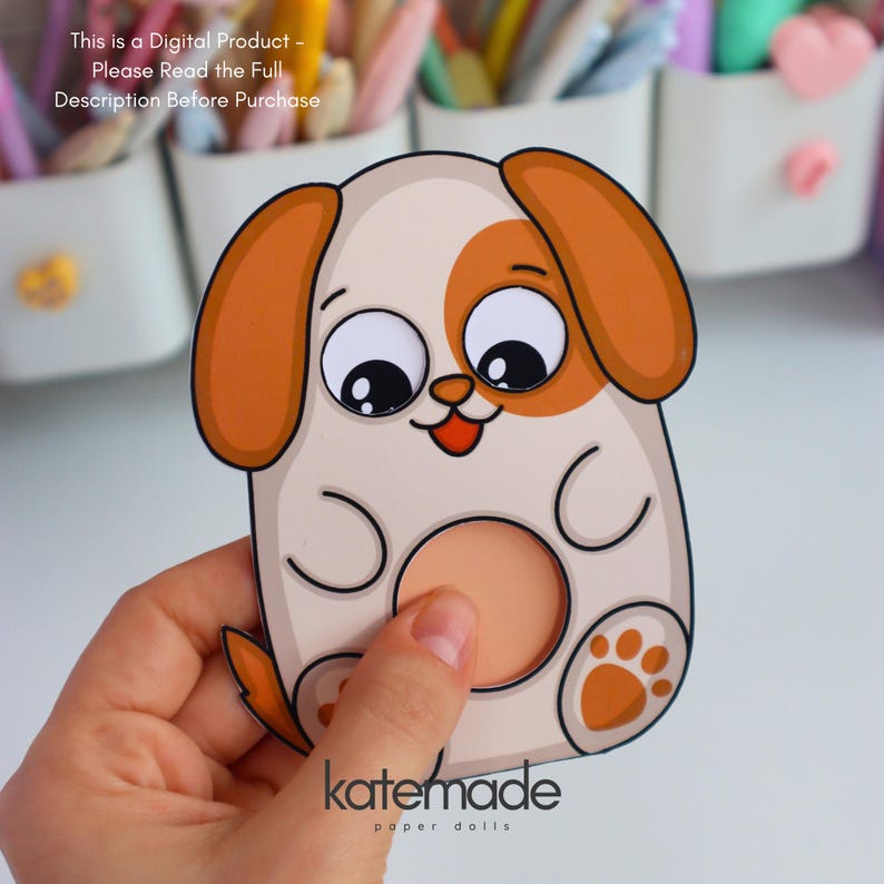 May include: A cartoon dog paper doll with a white body, brown ears, and a brown spot around one eye. The dog has a round, peach-colored belly and paw prints. The text "katemade paper dolls" is at the bottom. The text "This is a Digital Product - Please Read the Full Description Before Purchase" is at the top.