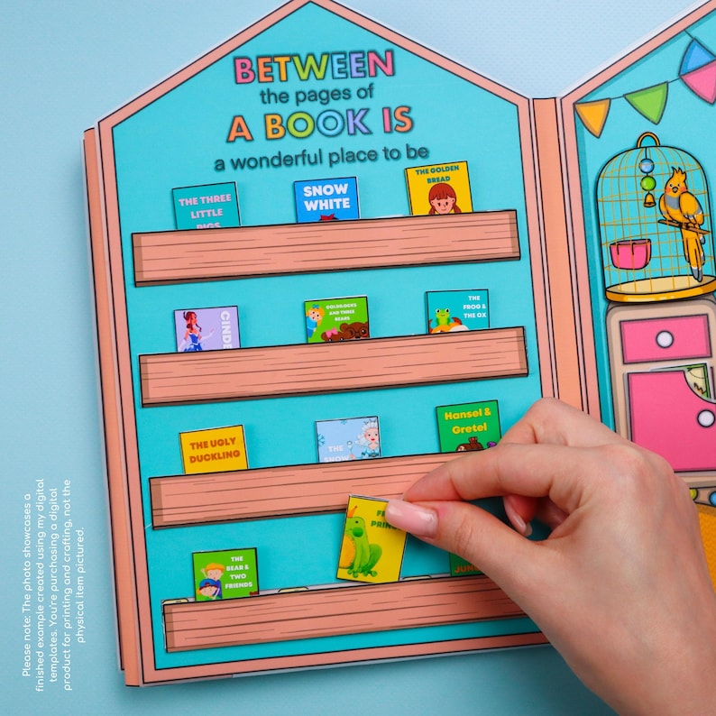 May include: A colorful children's book display with the text "BETWEEN the pages of A BOOK IS a wonderful place to be." Miniature book covers are arranged on shelves, including titles like "Snow White" and "The Frog and the Ox."