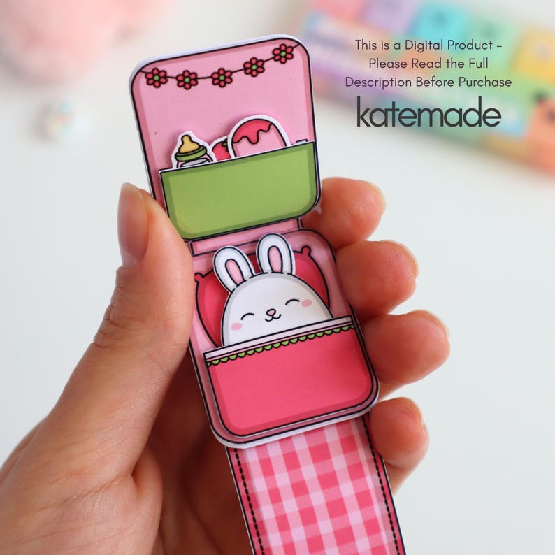 May include: A pink paper craft featuring a cartoon bunny in a bed, with a green container holding a bottle and a dessert. The top has a floral design. Text on the image reads: "This is a Digital Product - Please Read the Full Description Before Purchase katemade."